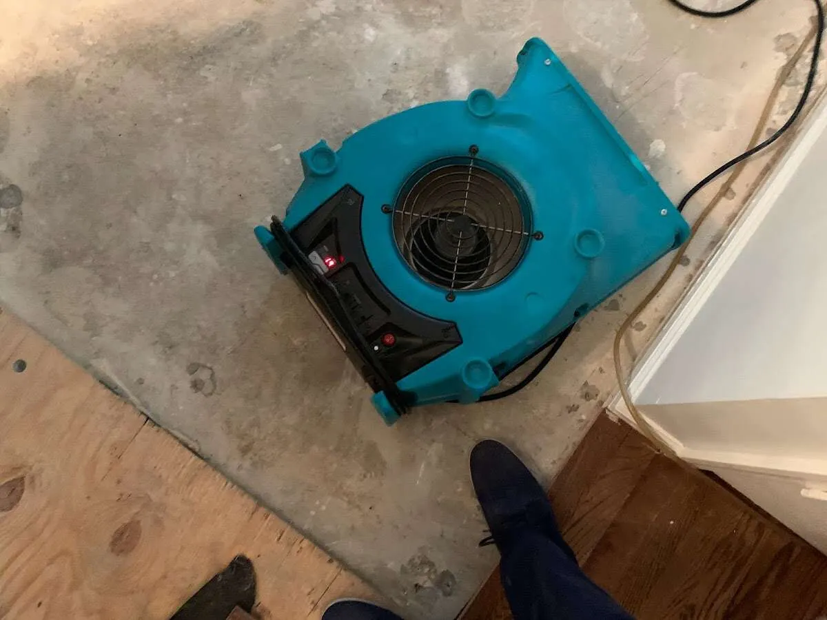 Air mover drying subfloor during Commercial Water Damage Restoration in Schoolcraft